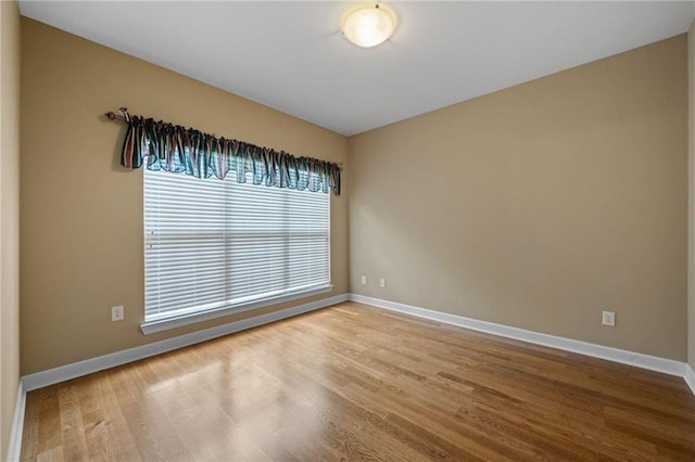 empty room with hardwood / wood-style flooring