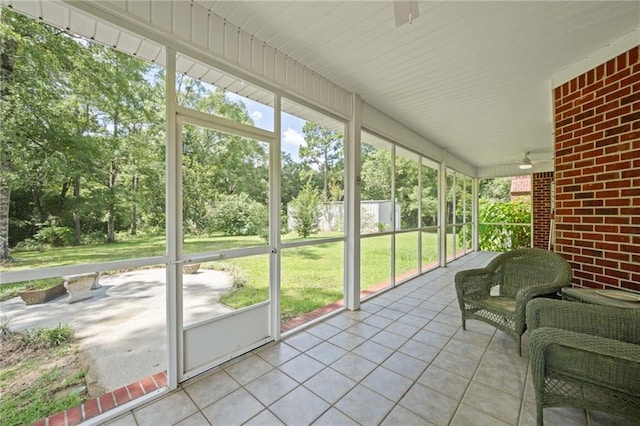 unfurnished sunroom featuring ceiling fan