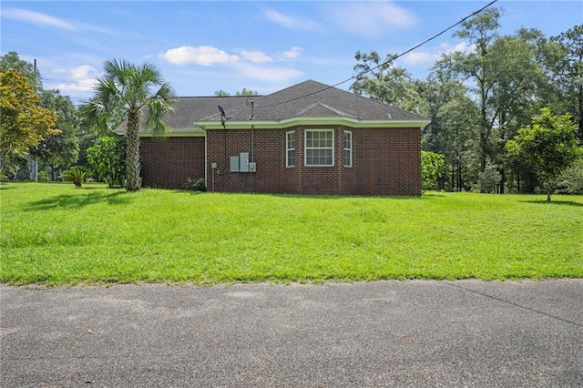 view of side of home featuring a yard