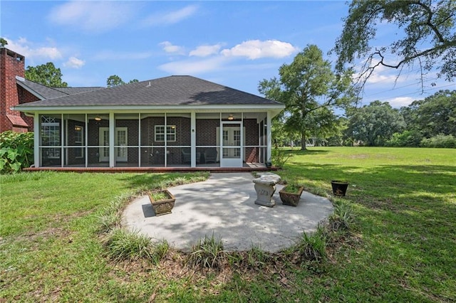 rear view of house featuring a sunroom, a yard, and a patio area