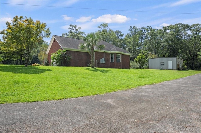 view of side of home with a lawn