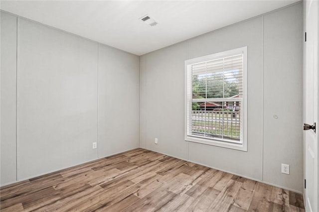 spare room with light hardwood / wood-style floors