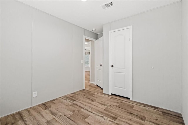 spare room with light hardwood / wood-style floors