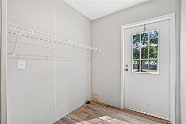 clothes washing area featuring light hardwood / wood-style floors