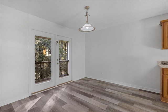 unfurnished dining area featuring hardwood / wood-style flooring