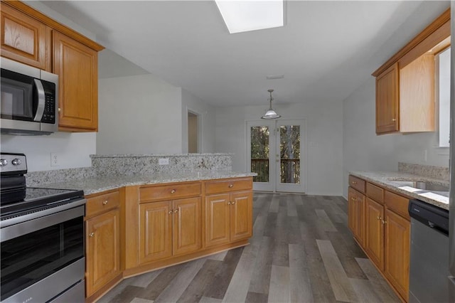 kitchen featuring pendant lighting, french doors, dark hardwood / wood-style floors, appliances with stainless steel finishes, and light stone counters