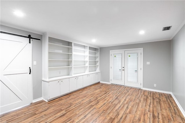 601 Willow Brook Run E, Mobile, AL 36608 - entryway with light wood finished floors, a barn door, crown molding, french doors, and recessed lighting