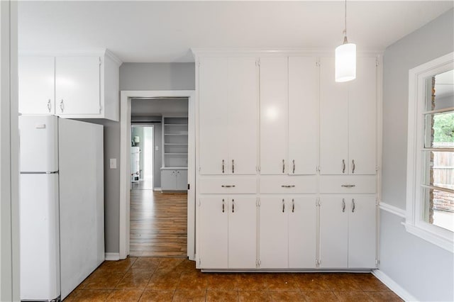 601 Willow Brook Run E, Mobile, AL 36608 - kitchen featuring freestanding refrigerator, white cabinetry, and decorative light fixtures