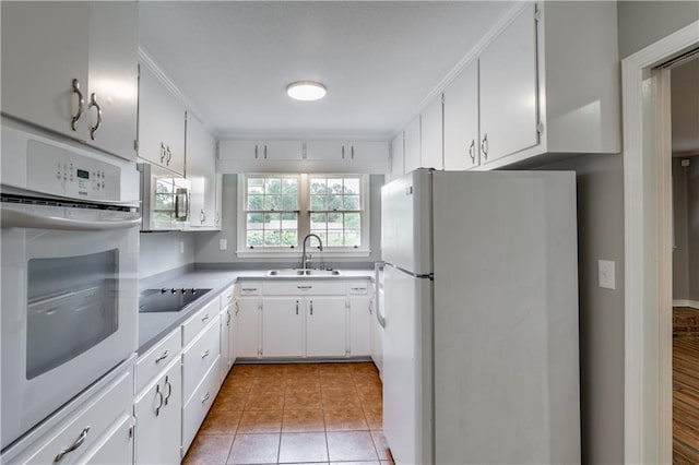 601 Willow Brook Run E, Mobile, AL 36608 - kitchen with white appliances, light countertops, white cabinetry, ornamental molding, and light tile patterned floors