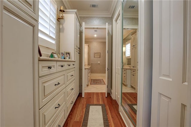 corridor with ornamental molding, dark wood-type flooring, and a healthy amount of sunlight