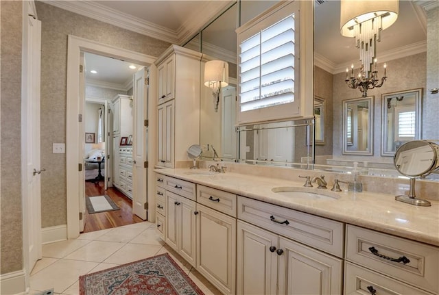 bathroom featuring ornamental molding, a wealth of natural light, vanity, and wood-type flooring