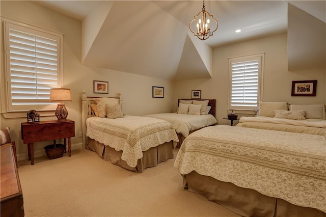 bedroom featuring a notable chandelier, lofted ceiling, and carpet flooring