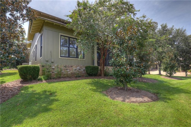 view of side of property with a lawn