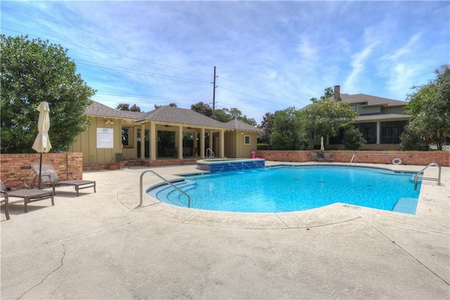 view of swimming pool featuring a patio and a community hot tub