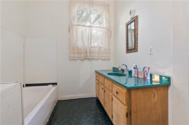 bathroom featuring vanity and a bath