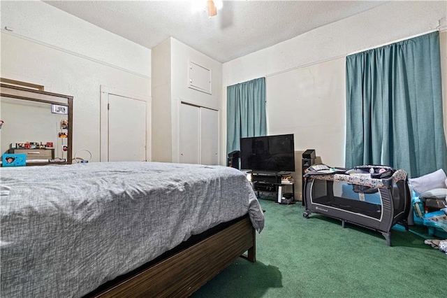 carpeted bedroom with ceiling fan and a closet