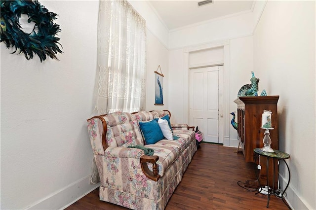 sitting room featuring dark wood-type flooring and ornamental molding