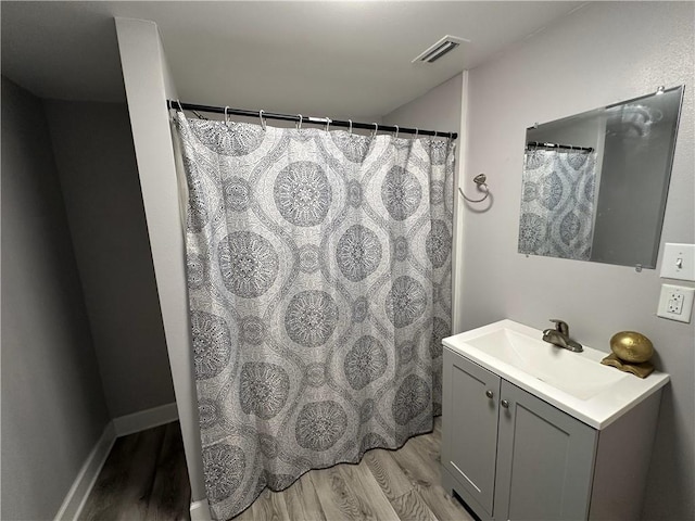 bathroom featuring vanity and hardwood / wood-style floors