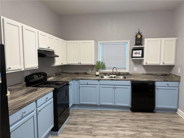 kitchen with white cabinetry, sink, light hardwood / wood-style floors, and black appliances