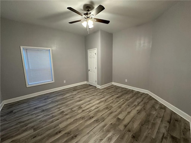 unfurnished room featuring ceiling fan and dark hardwood / wood-style flooring