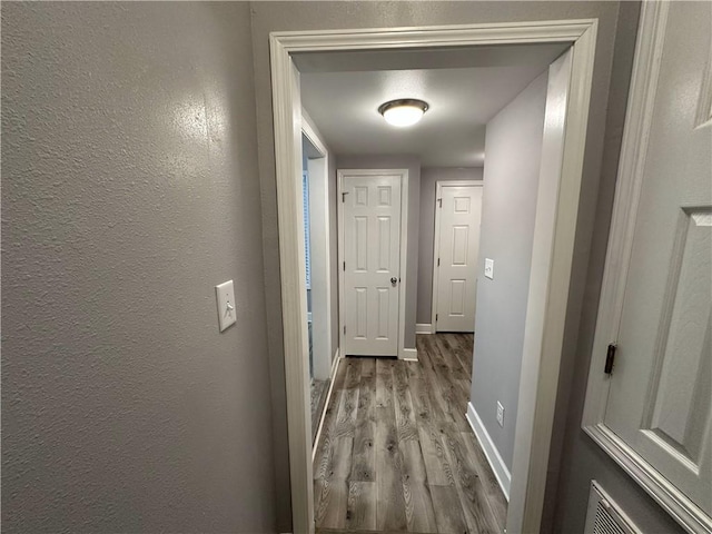 hallway with light wood-type flooring