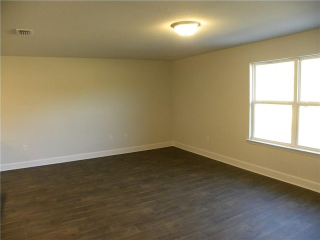 unfurnished room featuring dark hardwood / wood-style floors