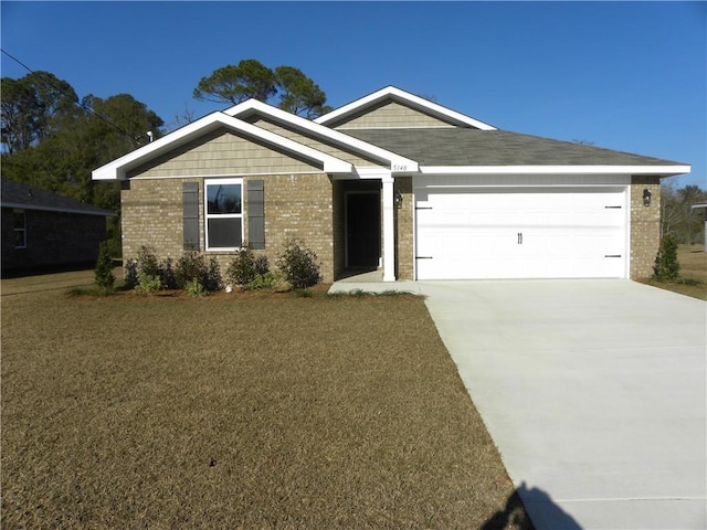 view of front of house with a front yard and a garage