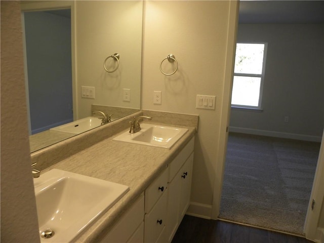 bathroom with hardwood / wood-style floors and vanity