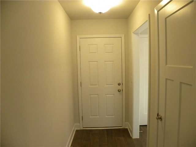 doorway with dark wood-type flooring