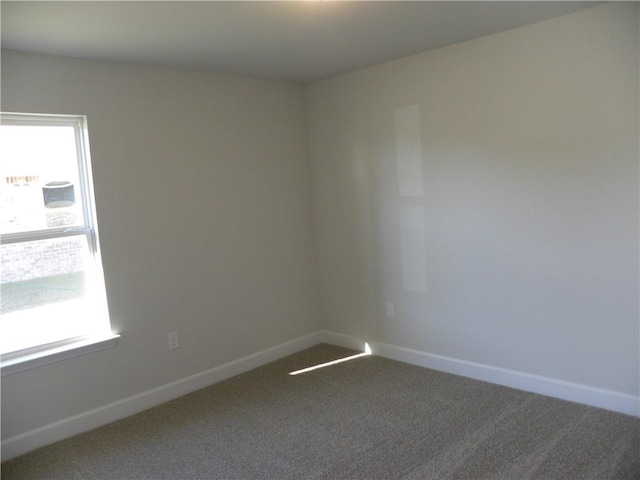 unfurnished room with carpet flooring and plenty of natural light