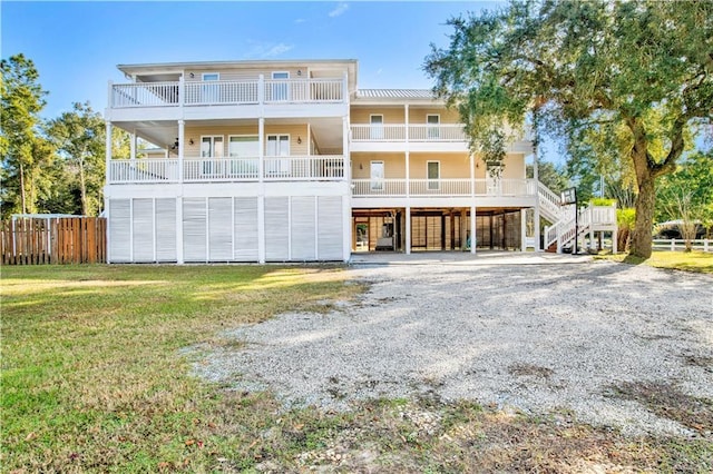 rear view of property featuring a yard and a carport