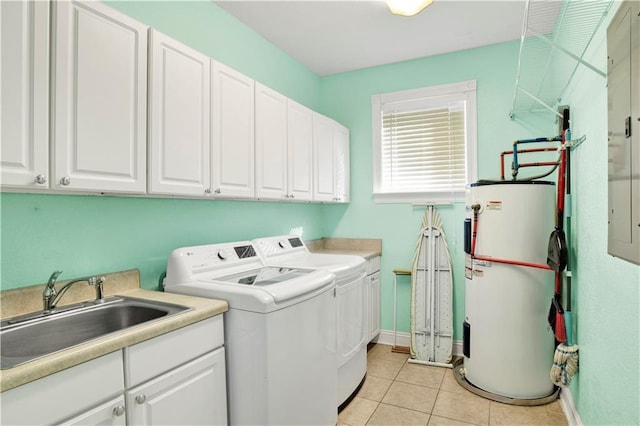 laundry room with cabinets, sink, washer and dryer, water heater, and light tile patterned flooring