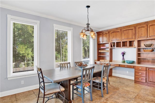 dining area with plenty of natural light, built in desk, ornamental molding, and light tile patterned floors