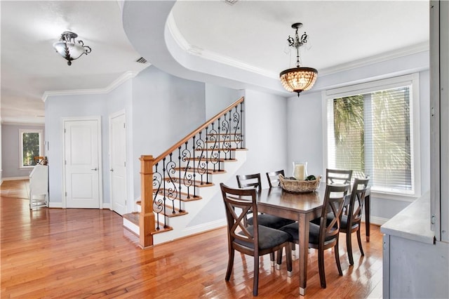 dining area featuring hardwood / wood-style floors and ornamental molding