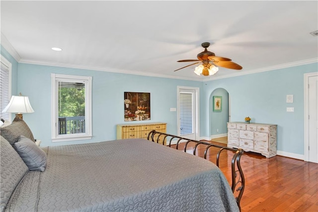 bedroom with wood-type flooring, ceiling fan, and ornamental molding