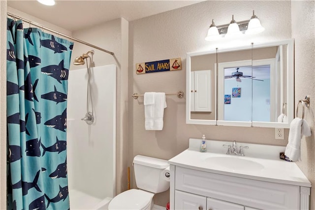 bathroom featuring ceiling fan, curtained shower, vanity, and toilet