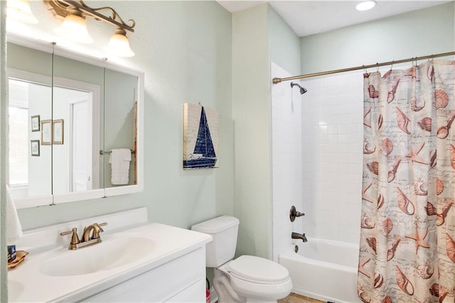 full bathroom with shower / tub combo with curtain, vanity, and toilet