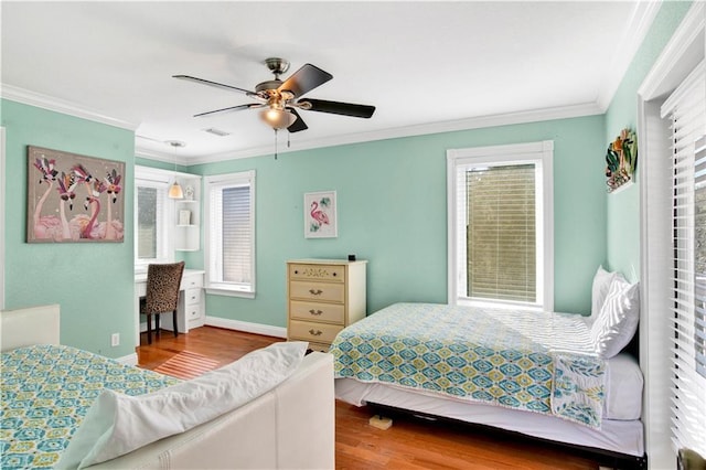 bedroom featuring multiple windows, hardwood / wood-style flooring, ceiling fan, and ornamental molding