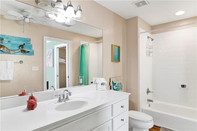 full bathroom featuring vanity, ceiling fan, toilet, and shower / bath combo with shower curtain