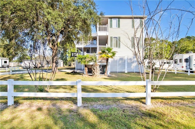 exterior space with a front yard and a balcony