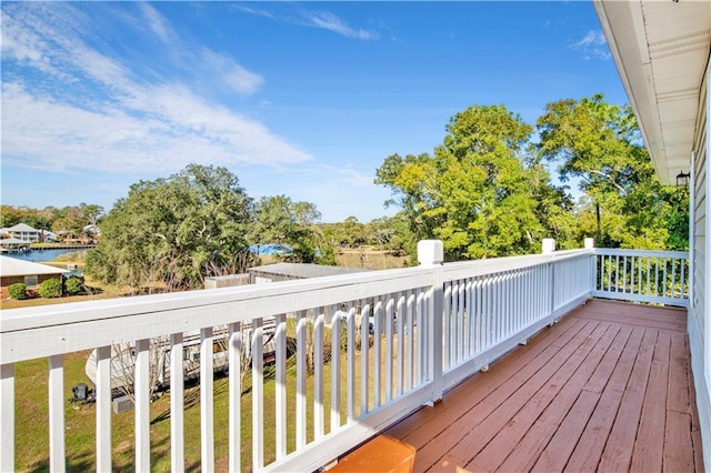 wooden terrace featuring a water view