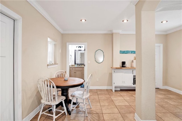 dining space with light tile patterned floors and ornamental molding