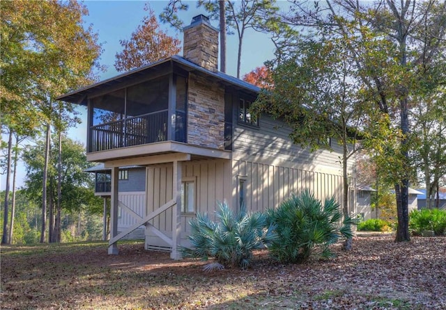 back of property with a sunroom