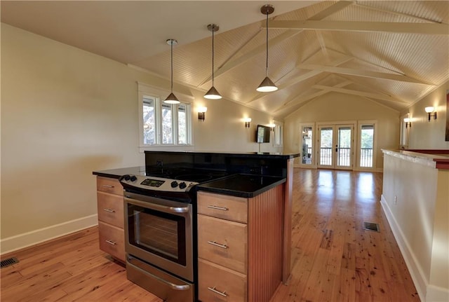 kitchen featuring plenty of natural light, stainless steel stove, decorative light fixtures, and light hardwood / wood-style flooring