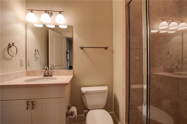 bathroom with vanity, toilet, and a shower with door