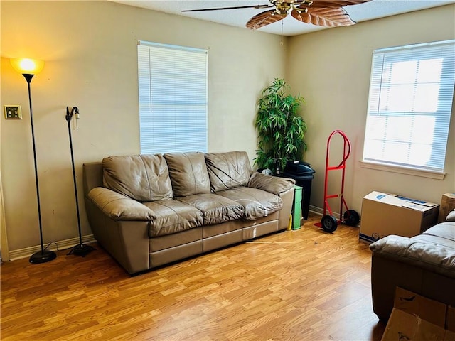 living room with ceiling fan and light hardwood / wood-style flooring