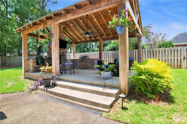 5555 Briarfield Ln, Mobile, AL 36693 - fenced backyard with exterior kitchen, a patio area, and ceiling fan