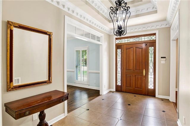 5555 Briarfield Ln, Mobile, AL 36693 - foyer featuring a chandelier, tile patterned flooring, ornamental molding, and a tray ceiling