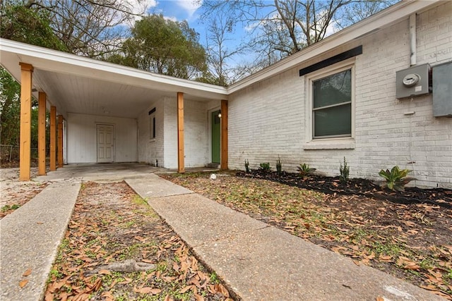 doorway to property featuring a carport