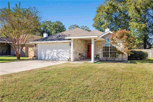 view of front of home with a front yard and a garage